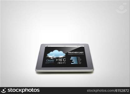 electronics, technology, weather cast and modern gadget concept - close up of tablet pc computer with meteo forecast over gray background
