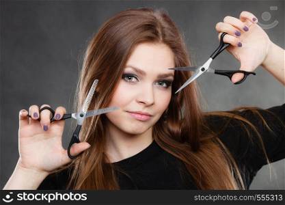 Elegance and classy. Fashion style of hairdo. Female professionalist with scissors. Elegant woman presents her hairdresser's saloon.. Professional elegant female barber with scissors.