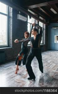 Elegance couple on ballrom dance training in class. Female and male partners on professional pair dancing in studio. Elegance couple on ballrom dance training in class