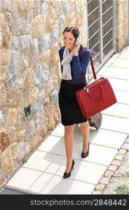 Elegance woman leaving home luggage calling phone businesswoman busy going