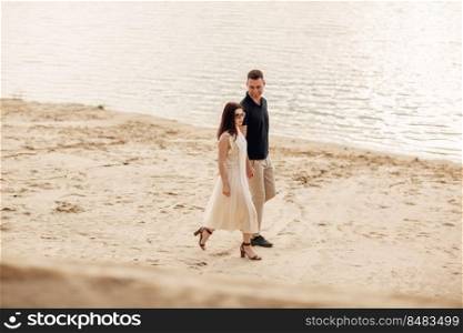 elegant and stylish woman and man in love are walking along the lake. Happy moments together. love story.. elegant and stylish woman and man in love are walking along the lake. Happy moments together. love story