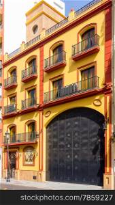 Elegant apartment building with a large door carriages in the city of Malaga, Spain