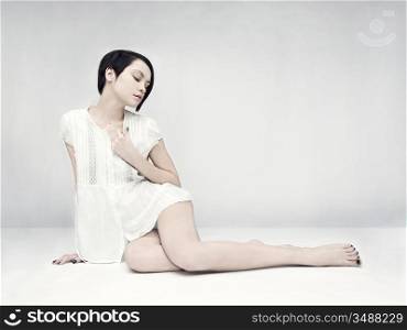 Elegant beautiful sitting lady on white background