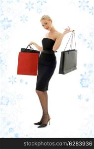 elegant blond with shopping bags and snowflakes