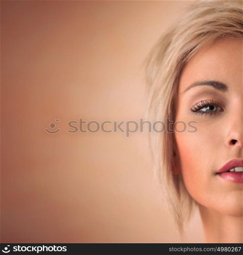Elegant blonde beauty half face closeup portrait with copyspace