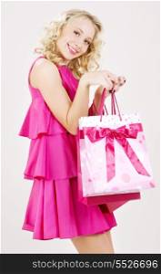 elegant blonde girl with pink shopping bags