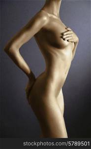 elegant body-art. Nude woman with gold skin