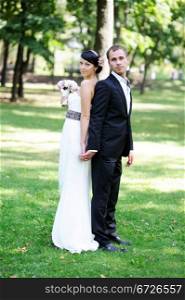 Elegant bride and groom posing together outdoors on a wedding day