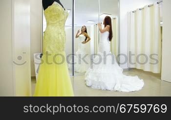 Elegant Bride Trying On Wedding Dress in Bridal Boutique, Long Shot