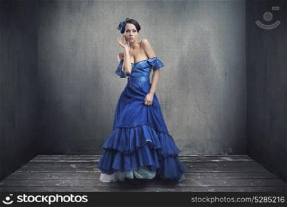 Elegant brunette woman posing in the grungy room
