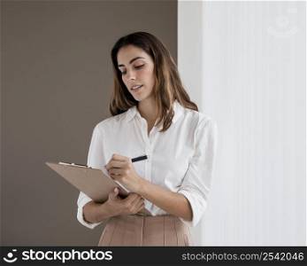 elegant businesswoman holding clipboard