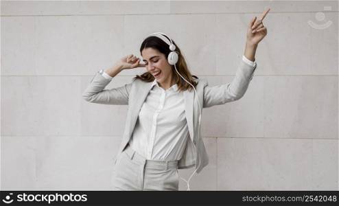 elegant businesswoman listening music headphones