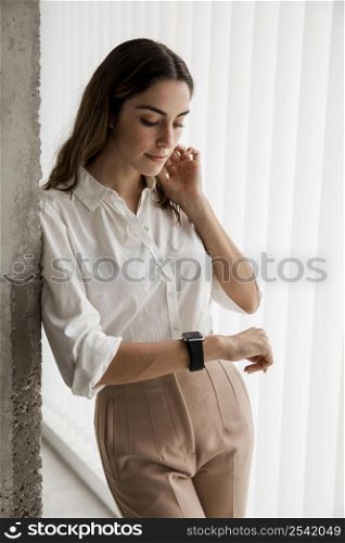 elegant businesswoman looking her smartwatch
