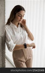 elegant businesswoman looking her smartwatch