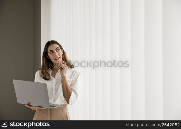 elegant businesswoman using laptop with copy space