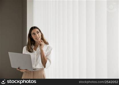 elegant businesswoman using laptop with copy space