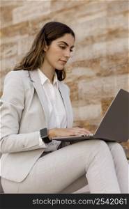 elegant businesswoman with smartwatch working laptop