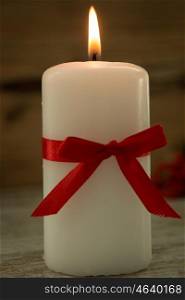 Elegant candle decorated for Christmas. Brighten up your illusion