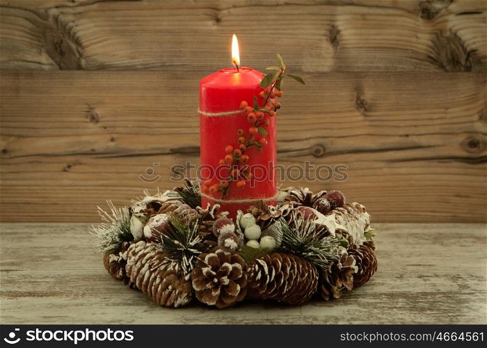 Elegant centerpiece for the Christmas table with a candle on a natural wreath