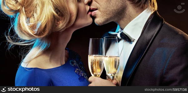 Elegant couple kissing and drinking champagne