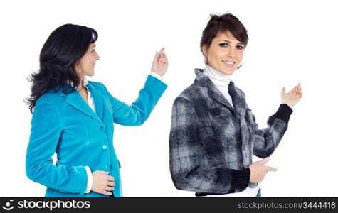 Elegant couple of businesswoman pointing something on a over a white background