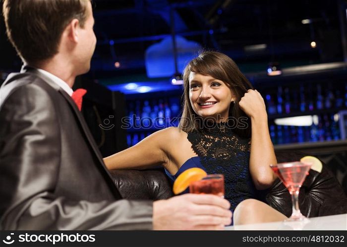 Elegant couple. Young handsome man in bar accompanied by elegant lady