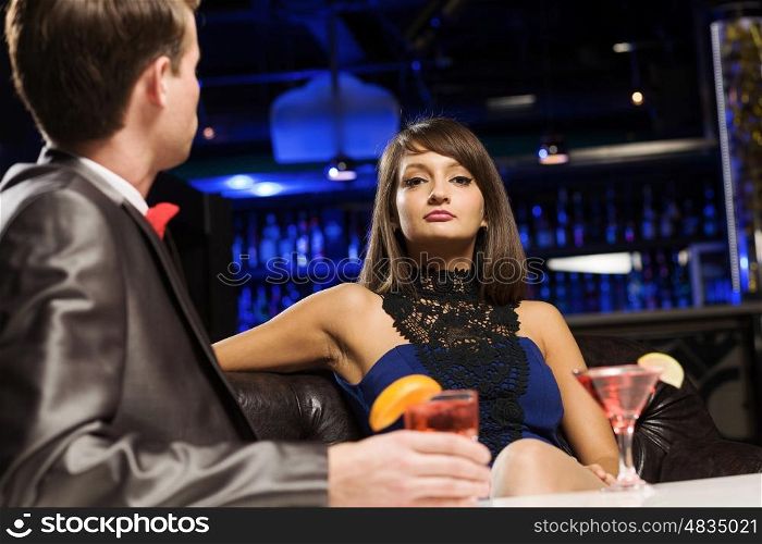 Elegant couple. Young handsome man in bar accompanied by elegant lady