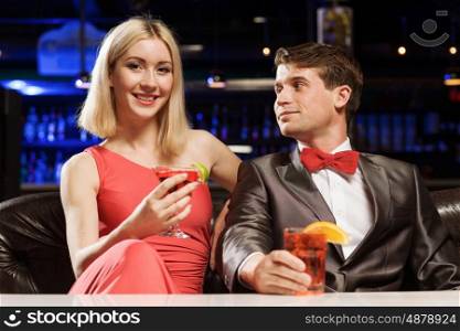 Elegant couple. Young handsome man in restaurant accompanied by elegant lady