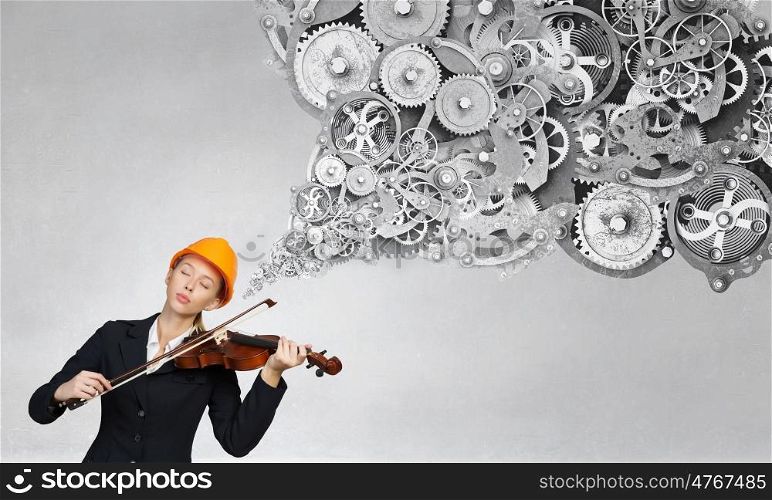 Elegant engineer woman. Young engineer woman with closed eyes playing violin instrument