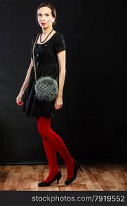 Elegant fashion outfit. Fashionable woman legs in red vivid color pantyhose black shoes and gray handbag