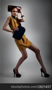 Elegant fashionable artistic woman in contemporary dress posing. Studio shot