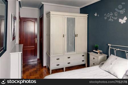 Elegant furnished double bedroom with bed, bedside table and closet. Elegant furnished double bedroom interior