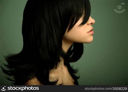 Elegant girl with magnificent black hair. Studio portrait.