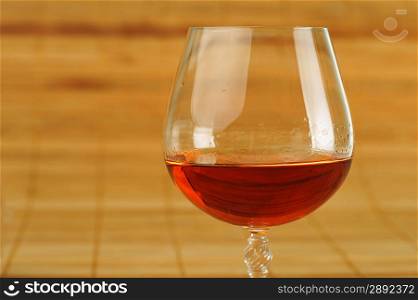elegant glass of cognac on bamboo napkin