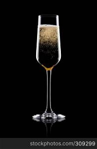 Elegant glass of yellow champagne with bubbles on black background with reflection