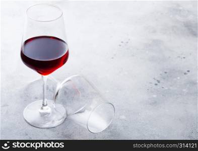 Elegant glasses of red wine on kitchen table background.