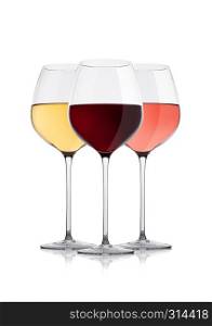 Elegant glasses of white red and pink rose wine on white background