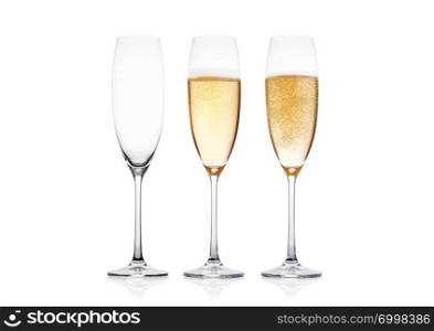 Elegant glasses of yellow champagne with bubbles on white background with reflection