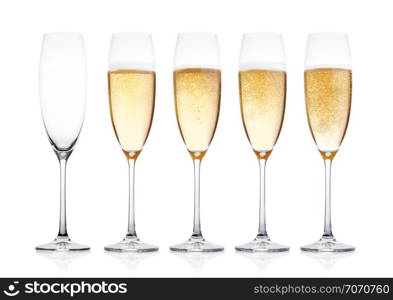 Elegant glasses of yellow champagne with bubbles on white background with reflection