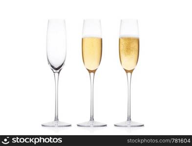Elegant glasses of yellow champagne with bubbles on white background with reflection