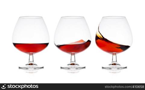 Elegant glasses with brandy cognac alcohol drink isolated on white background