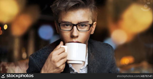 Elegant guy drinking an aromatic coffee