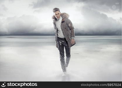 Elegant guy walking on the frozen lake