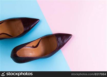 Elegant high heel shoes. Pair of Elegant high heel shoes on blue and pink background