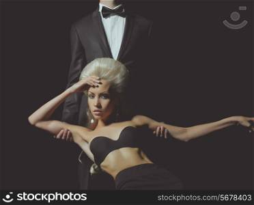 Elegant lady blonde at the hands of a young man in suit