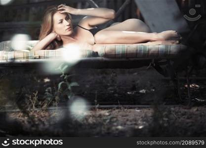 Elegant lady in black lingerie relaxing outdoors