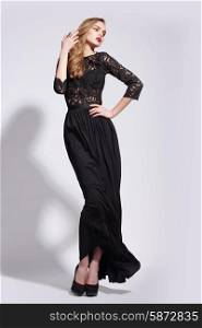 Elegant Luxurious Woman posing in Long Dress