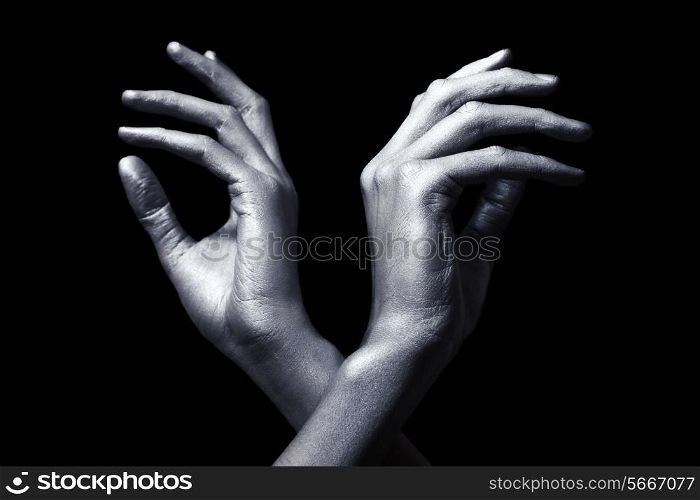 elegant male hands in silver paint isolated on black background