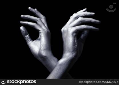 elegant male hands in silver paint isolated on black background