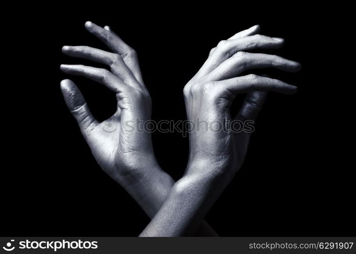 elegant male hands in silver paint isolated on black background